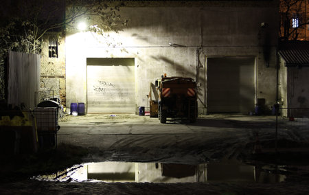 view on a mystical scene of a garage and vehicle by night