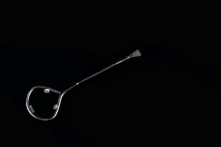 One paint can opener on black backgroundの写真素材