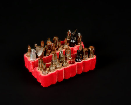 Screw diver bits in a red storage container