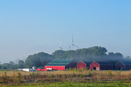Rural landscape with barns trees and wind turbines in Southern Ontarioの写真素材