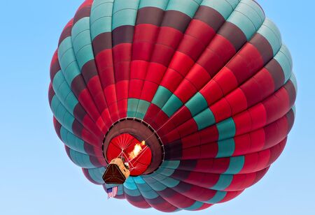 Colorful hot air balloon rising image from belowの写真素材