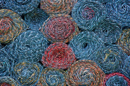 Colorful rolled chain link, swirled and stacked in circle pattern.の写真素材