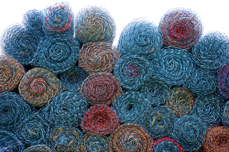 Colorful rolled chain link, swirled and stacked in circle pattern, fades to white at the top.の写真素材