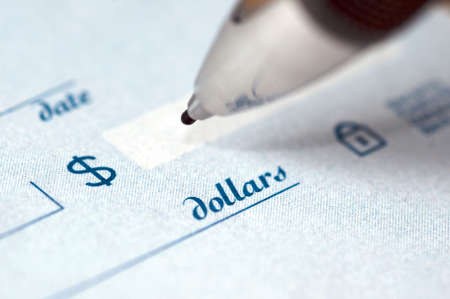 Extremem close up of the dollar amount on a check being written by an ink pen.の写真素材
