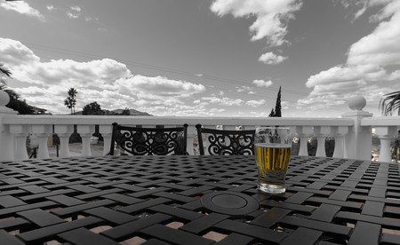 a beer on a table under a cloud and clear skyの写真素材