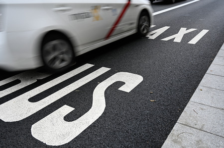 Bus taxi and bicycle lanes with limited speedの写真素材