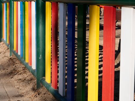 wooden fence with colors of children's playground enclosure in a park in Madridの写真素材
