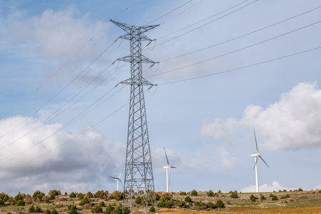 Wind Turbines and High Voltage Electric Transmission Tower Energy Pylonの写真素材