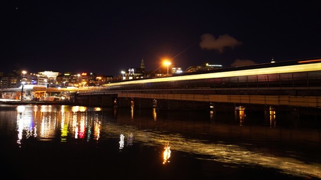 train light trail flying through night scape of Stockholmのeditorial素材