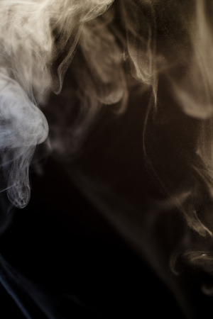 abstract shapes formed by scrolls of incense smokeの写真素材