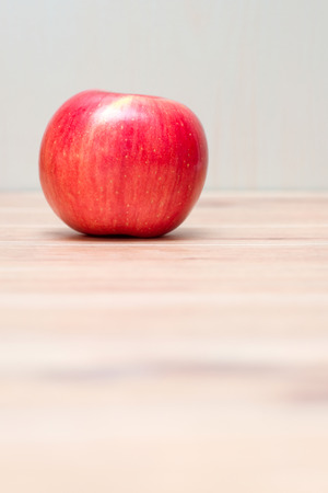One red apple on wood tableの写真素材