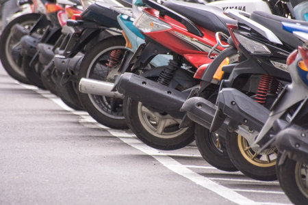 Taipei, Taiwan - June 10, 2018 : A row of motorcycle parking along the roadside in Taipei's street,...
