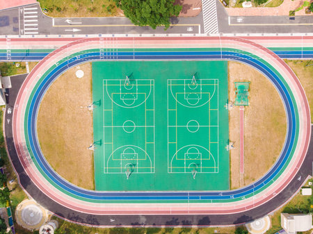 Taipei, Taiwan - June 3, 2018: Running track and basketball court at the stadium, color is...