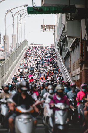 Taipei, Taiwan - July 6, 2018: Motorcycles go down the Taipei bridge during rush hour in the morning.のeditorial素材