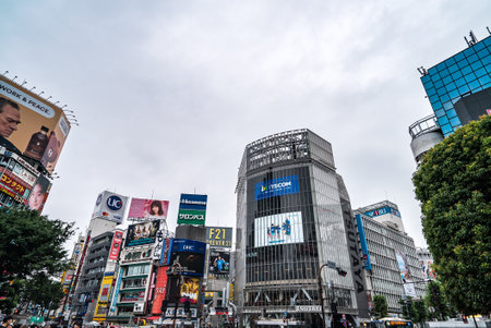 Tokyo, JP - June 21, 2018: Scenery of landmark business building and billboards in Shibuya City, with rush crowd of people and tourists in street.のeditorial素材