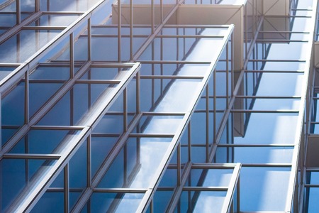 underside panoramic and perspective view to steel blue glass high rise building skyscrapers, business concept of successful industrial architectureの写真素材