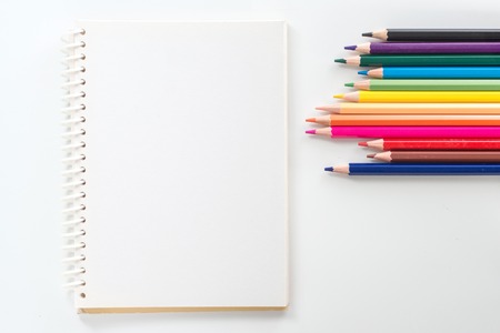 notepad with color pencil on white table view from aboveの写真素材