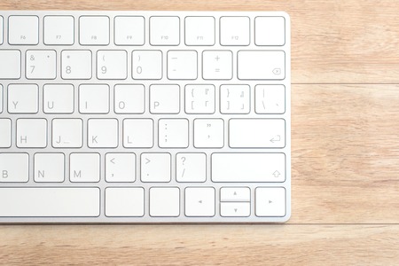 View from above at the computer on the wooden desk.の写真素材