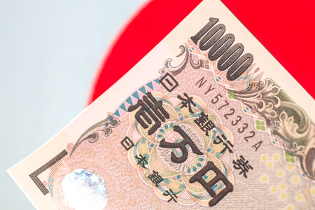 Japanese currency notes , Japanese Yen on japanese flag.の写真素材