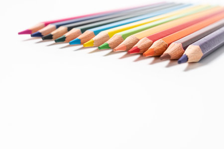 many colored pencils on white background