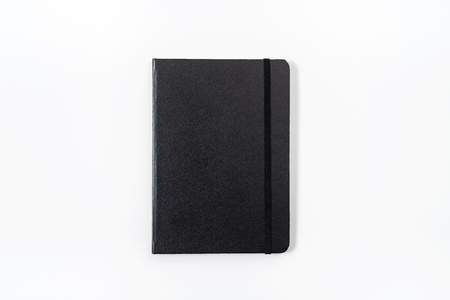 black notebook on white backgroundの写真素材