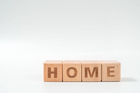 word HOME on wood cube dices on white background.の写真素材
