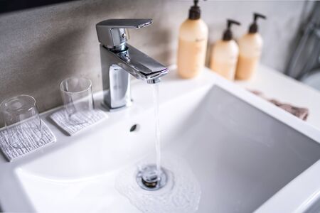 Modern bathroom faucet, Very high end faucet, sink, and counter in a luxury bathroomの写真素材