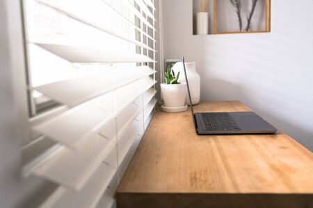 Workplace near the window with laptop and computer. Copy space. use in Traditional Chinese Alphabet operating system.の写真素材