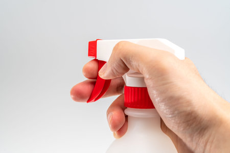 Protective face mask and sanitizer gel dispenser on white background