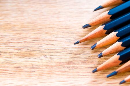 black pencils isolated on wood surface background.Close up.の写真素材