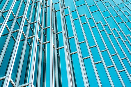 underside panoramic and perspective view to steel Tiffany blue glass high rise building skyscrapers, business concept of successful industrial architectureの写真素材