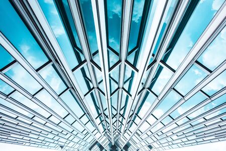 underside panoramic and perspective view to steel blue glass high rise building skyscrapers, business concept of successful industrial architectureの写真素材