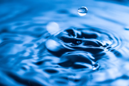 water drop splash in a glass blue colored
