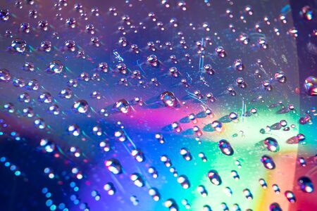 water drops on dvd media, water drops on colorful backgroundの写真素材