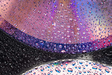 water drops on dvd media, water drops on colorful backgroundの写真素材