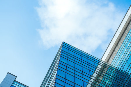 underside panoramic and perspective view to steel blue glass high rise building skyscrapers,...