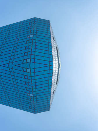 underside panoramic and perspective view to steel blue glass high rise building skyscrapers, business concept of successful industrial architectureの写真素材
