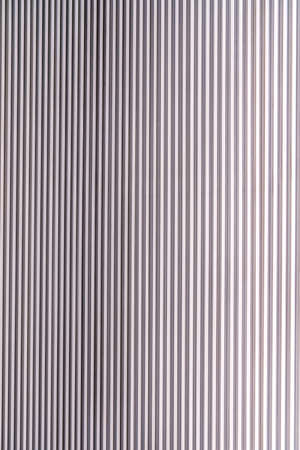 The texture of the wall is made of metal coating of huge aluminum plates of relief shape with horizontal notches. A variety of metal siding close-upの写真素材