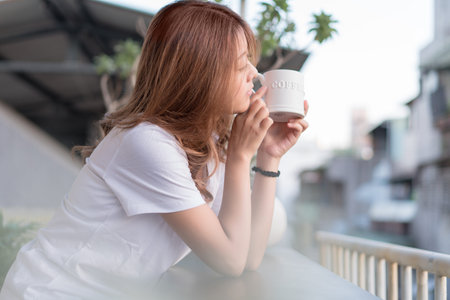 Young woman enjoying the cityscape side view from her hotel.