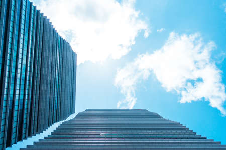 underside panoramic and perspective view to steel blue glass high rise building skyscrapers, business concept of successful industrial architectureの写真素材