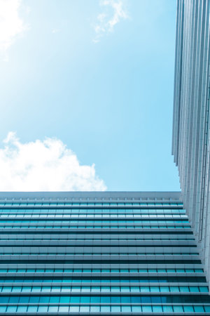 underside panoramic and perspective view to steel blue glass high rise building skyscrapers,...