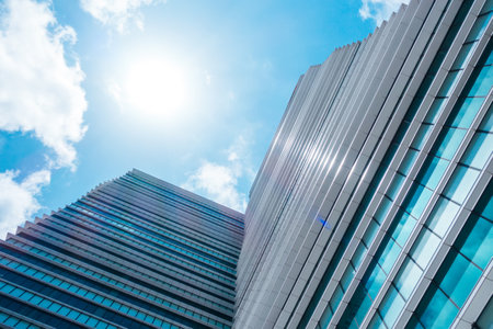 underside panoramic and perspective view to steel blue glass high rise building skyscrapers, business concept of successful industrial architectureの写真素材
