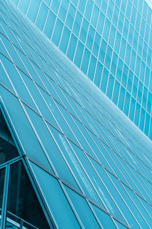 underside panoramic and perspective view to steel blue glass high rise building skyscrapers, business concept of successful industrial architectureの写真素材