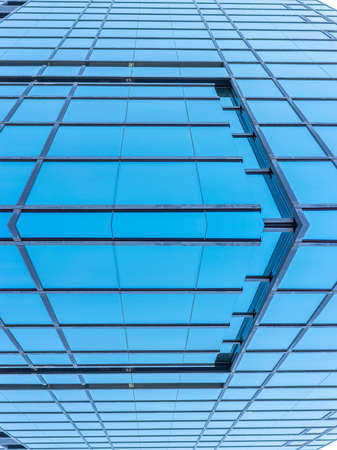 underside panoramic and perspective view to steel blue glass high rise building skyscrapers, business concept of successful industrial architectureの写真素材