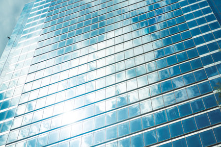 underside panoramic and perspective view to steel blue glass high rise building skyscrapers,...
