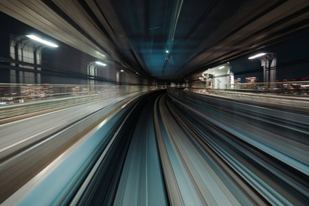 Motion blurred train moving inside tunnel with daylight in tokyo, japan.の写真素材