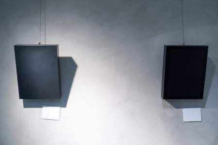 A Moment in Time: A Black Picture Frame Hanging on a Gray Concrete Wallの写真素材