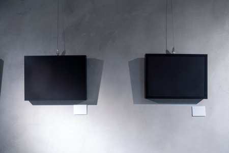 A Moment in Time: A Black Picture Frame Hanging on a Gray Concrete Wallの写真素材