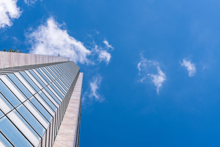 underside panoramic and perspective view to steel blue glass high rise building skyscrapers,...