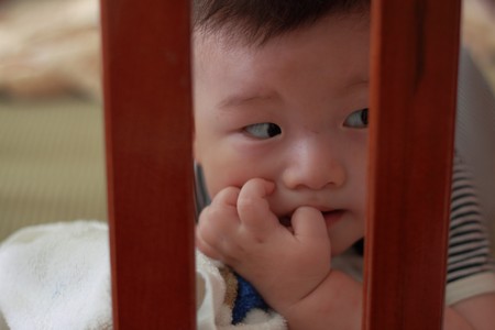 baby in bedの写真素材